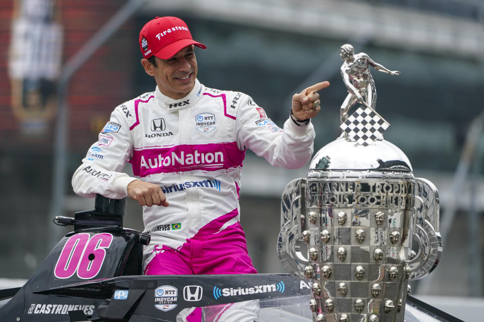 Helio Castroneves of Brazil, winner of the 2021 Indianapolis 500 auto race, poses during the traditional winners photo session at the Indianapolis Motor Speedway in Indianapolis, Monday, May 31, 2021. (AP Photo/Michael Conroy)