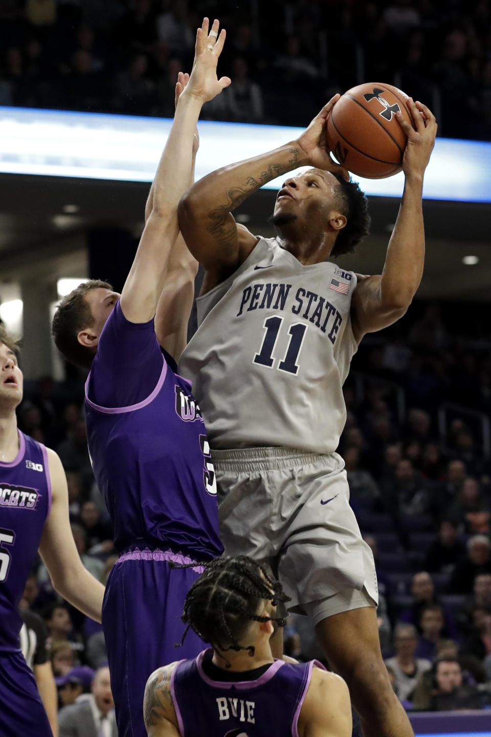 Penn State forward Lamar Stevens, right, goes up to shoot against Northwestern forward Robbie Beran during the first half of an NCAA college basketball game in Evanston, Ill., Saturday, March 7, 2020. (AP Photo/Nam Y. Huh)