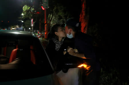 Du Yueting (R), 42, kisses Zhang Tongyu, 35, a goodbye outside their restaurant, in New Taipei City, Taiwan November 20, 2018. REUTERS/Ann Wang