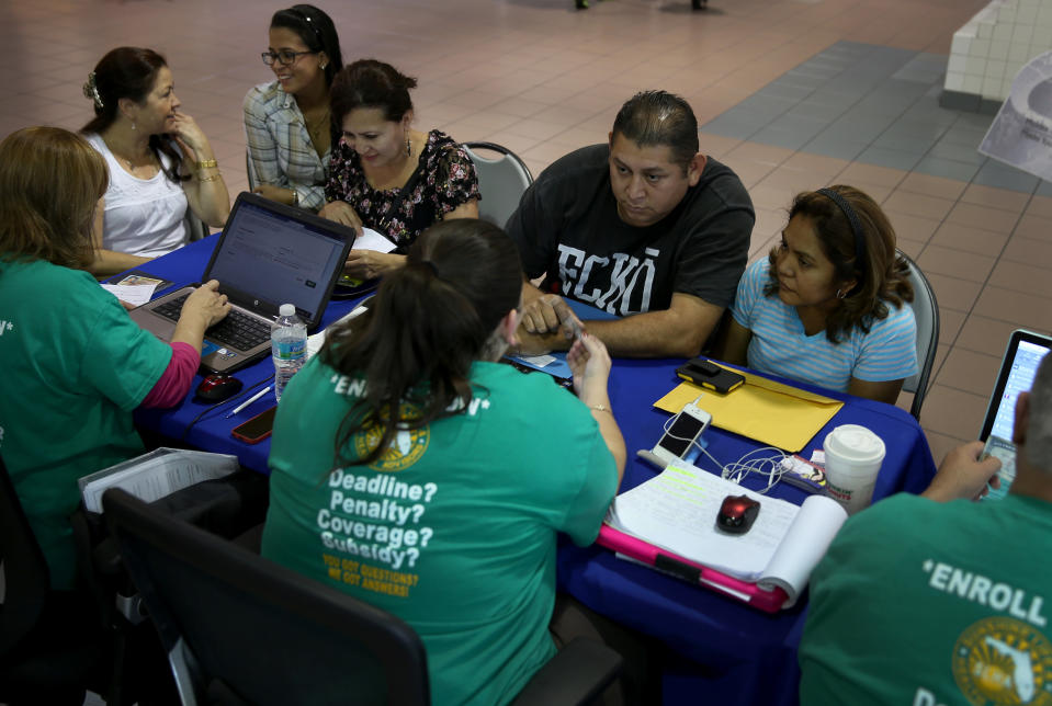 MIAMI, FL - DECEMBER 22: Rene Hernandez (2nd R) and his wife Nery Hernandez speak with Rosaly Hernandez an insurance agent with Sunshine Life and Health Advisors as they try to purchase health insurance under the Affordable Care Act at the kiosk setup at the Mall of Americas on December 22, 2013 in Miami, Florida.  Tomorrow is the deadline for people to sign up if they want their new health benefits to kick in on the 1st of January. People have until March 31, to sign up for coverage that would start later.  (Photo by Joe Raedle/Getty Images)