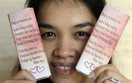 An enterprising housewife shows homemade chocolate bars in wrappers bearing love quotes, which she is selling for Valentine's Day in Manila's Makati financial district February 14, 2013. REUTERS/Erik De Castro