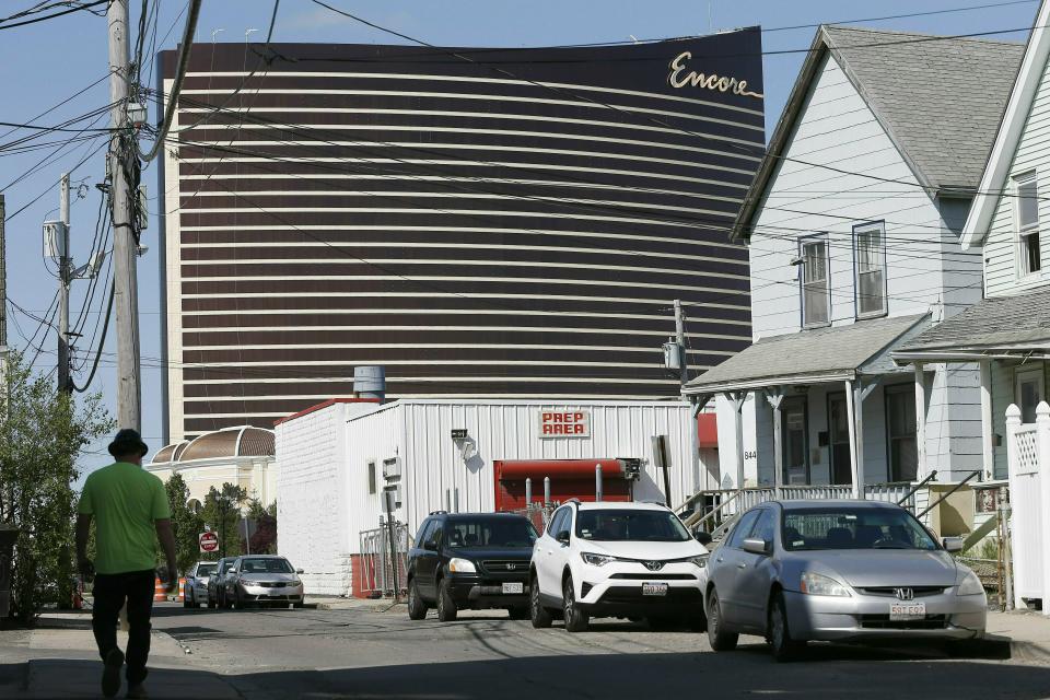 FILE - In this May 22, 2019 file photo, Encore Boston Harbor casino looms above the surrounding neighborhood in Everett, Mass. The casino is scheduled to open on Sunday, June 23. (AP Photo/Michael Dwyer, File)
