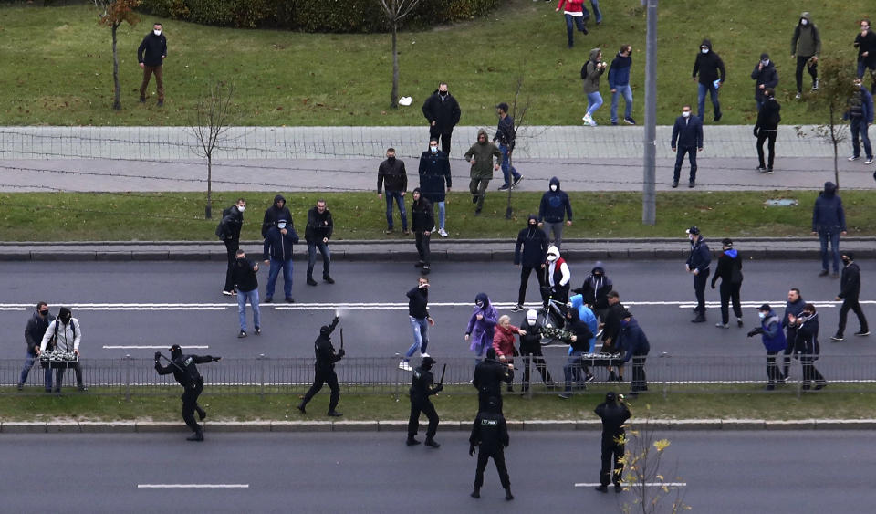 People clash with policemen during an opposition rally to protest the official presidential election results in Minsk, Belarus, Sunday, Oct. 11, 2020. Hundreds of thousands of Belarusians have been protesting daily since the Aug. 9 presidential election. (AP Photo)