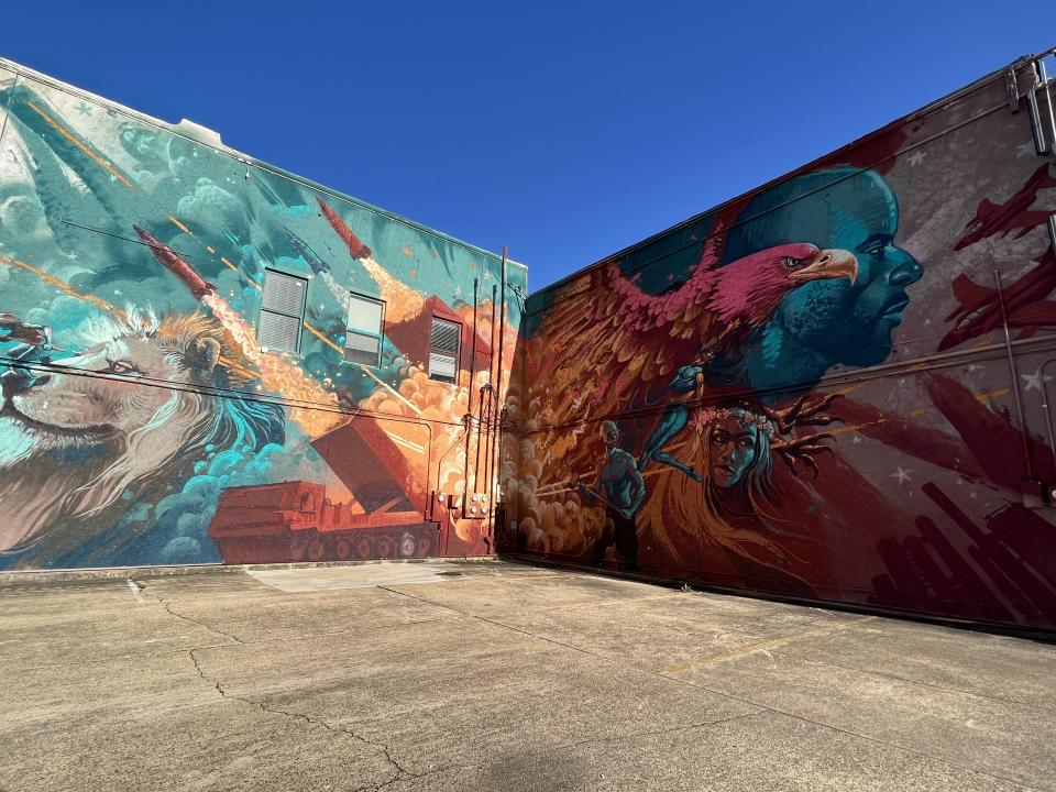 A resident in downtown Camden, Ark., commissioned artist Kiptoe to paint this mural on the side of his apartment building to promote the growing vibrancy of the small city. Prominently featured in the work are M270 launchers, which Lockheed Martin has made at its Camden facility since 1980. (Jen Judson/Staff)