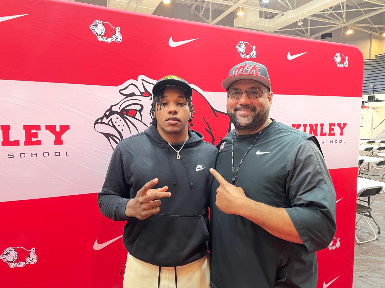 Canton McKinley football star Dante McClellan and head coach Antonio Hall take a photo after McClellan announced his verbal commitment to the University of Missouri on Monday, April 22 at Memorial Field House.