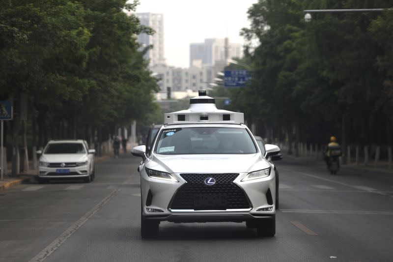 Lexus vehicle equipped with Pony.ai's autonomous driving system drives on a road during a test event, in Beijing