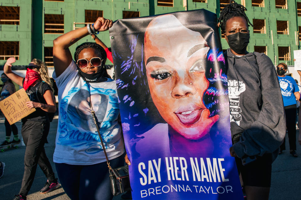 Two women hold a sign of Breonna Taylor during a rally on September 18, 2020 in Louisville, Kentucky. / Credit: Getty Images