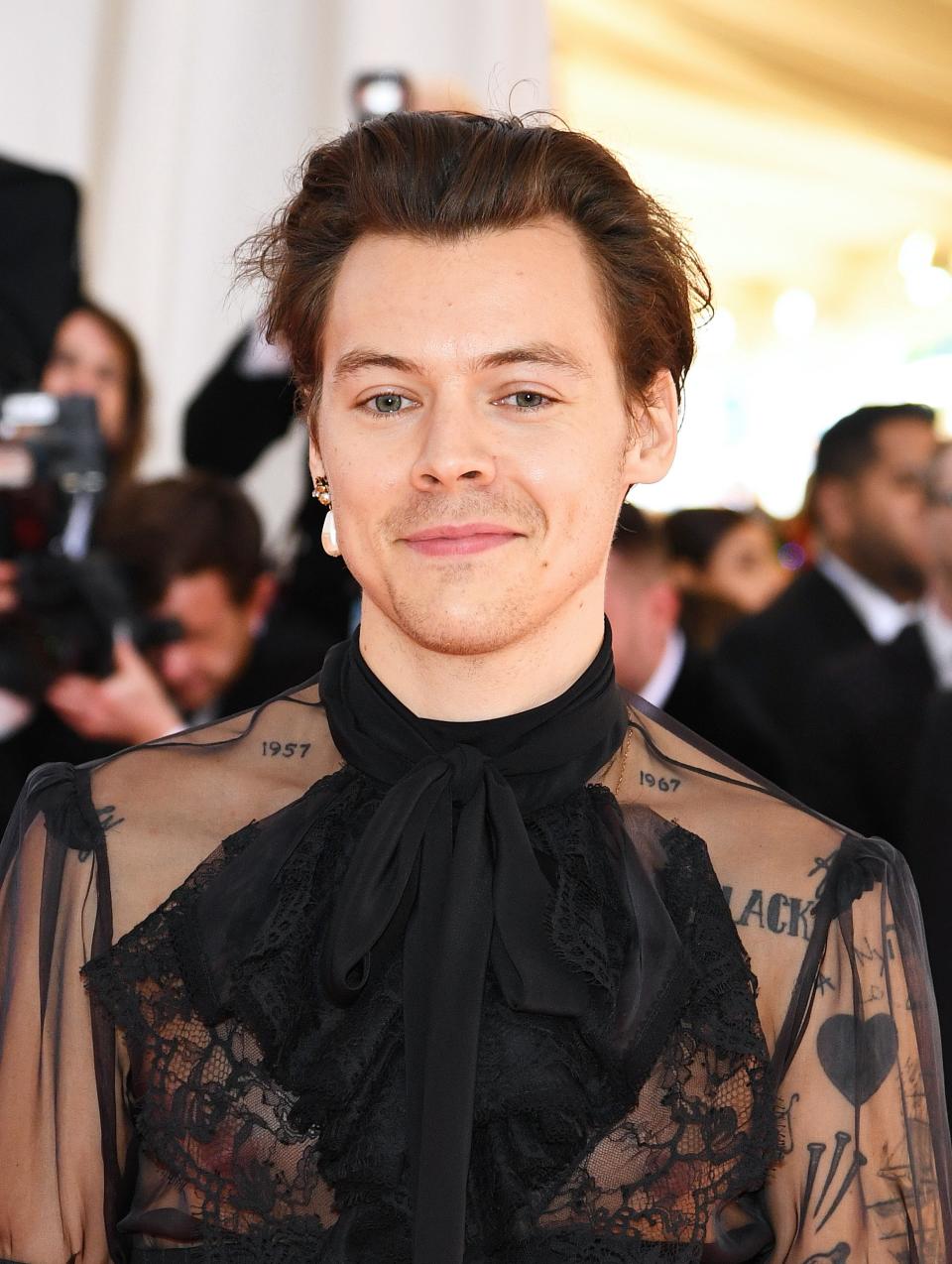 Harry Styles showed up at the Met Gala in a high-waisted Gucci jumpsuit that included a ruffled sheer blouse.