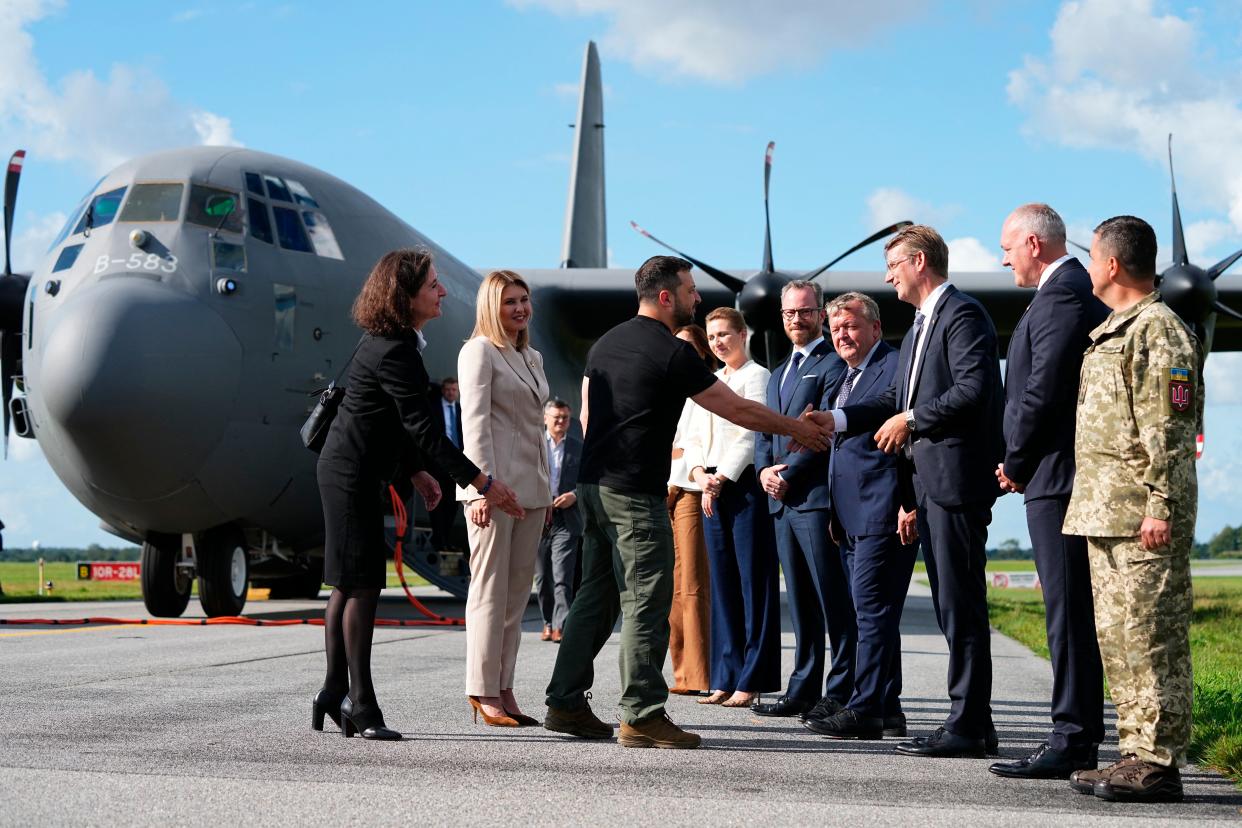 Volodymyr Zelensky (3rd L) and his wife Olena Zelenska are greeted by Denmark’s Crown Princess Mary (7thR) and Danish prime minister Mette Frederiksen (6th R) after arriving on the airfield in the Skrydstrup Airbase in Vojens (Ritzau Scanpix/AFP via Getty)