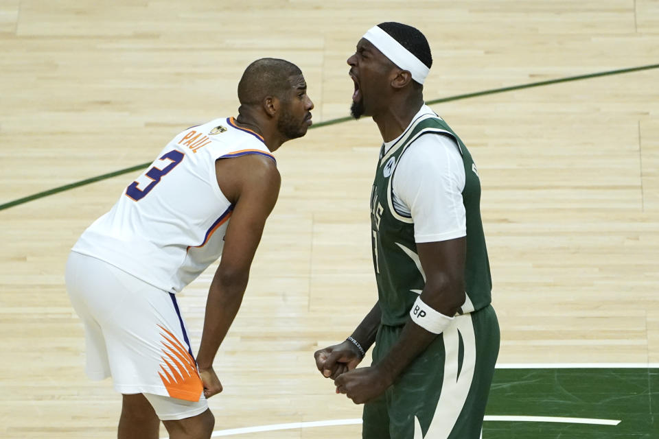 Milwaukee Bucks center Bobby Portis, right, reacts to a basket as Phoenix Suns guard Chris Paul (3) looks on during the second half of Game 3 of basketball's NBA Finals in Milwaukee, Sunday, July 11, 2021. (AP Photo/Paul Sancya)