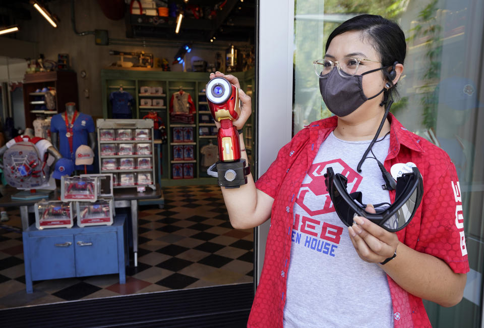 Cast Member Diana Ramirez holds Spider-Man goggles and a Repulsor Cannon at the Avengers Campus media preview at Disney's California Adventure Park on Wednesday, June 2, 2021, in Anaheim, Calif. (AP Photo/Chris Pizzello)