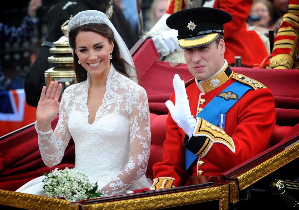 Prince William and the former Kate Middleton wave on the way to their wedding reception.