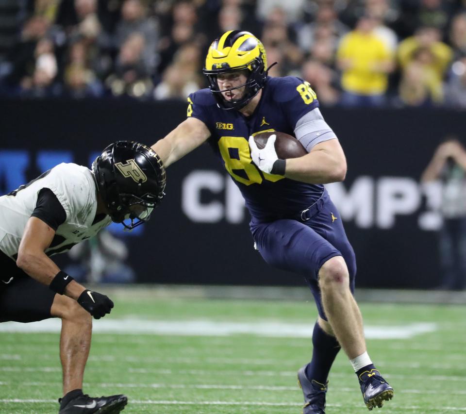 Michigan Wolverines tight end Luke Schoonmaker (86) makes a catch against Purdue Boilermakers safety Cam Allen (10) during second half action of the Big Ten Championship game at Lucas Oil Stadium in Indianapolis Saturday, December 03, 2022.