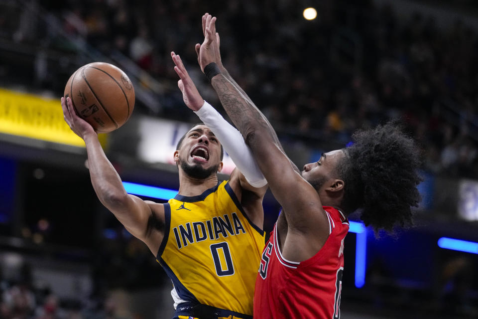 Indiana Pacers guard Tyrese Haliburton (0) shoots over Chicago Bulls guard Coby White (0) during the first half of an NBA basketball game in Indianapolis, Monday, Oct. 30, 2023. (AP Photo/Michael Conroy)