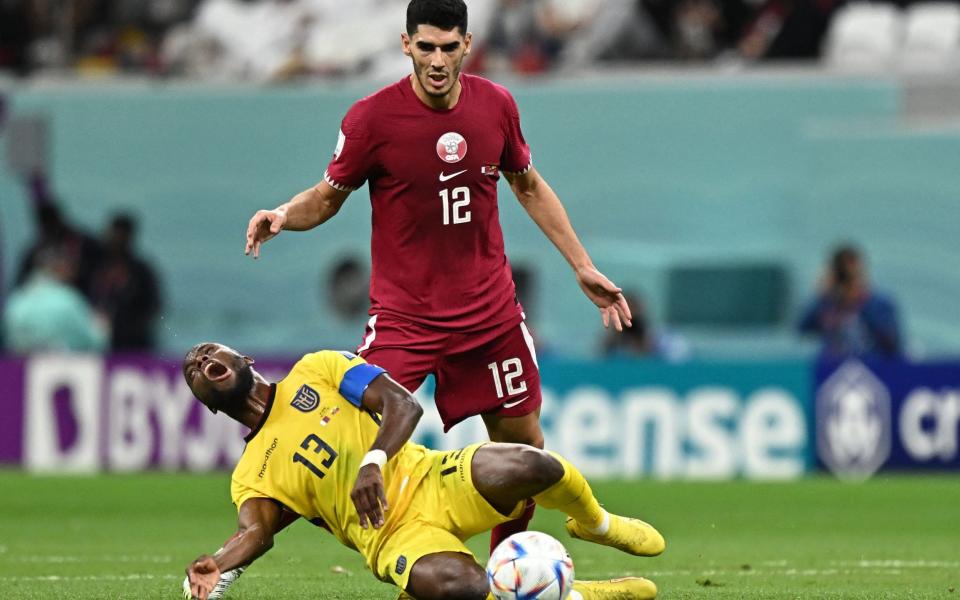 Enner Valencia (L) is tackled by Qatar's midfielder #12 Karim Boudiaf - AFP