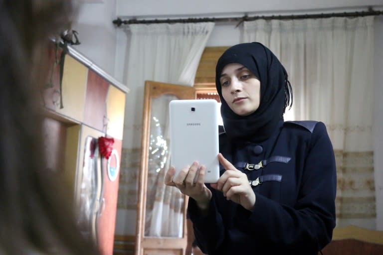 Fatimeh films her daughter as they prepare to post on Twitter in English about life in the besieged eastern districts of Syria's Aleppo, on October 12, 2016 The seven-year-old Syrian girl whose Twitter account from Aleppo gained international attention has fled her home amid heavy fighting, but she and her family are safe for now, her father said on December 6, 2016