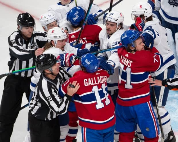 Montreal Canadiens and Toronto Maple Leafs players mix it up after the whistle during the second period of NHL playoff hockey action on Saturday. The federal government is expected to approve an exemption that would allow teams to cross the Canada-U.S. border without mandatory quarantine during playoffs. (Ryan Remiorz/The Canadian Press - image credit)