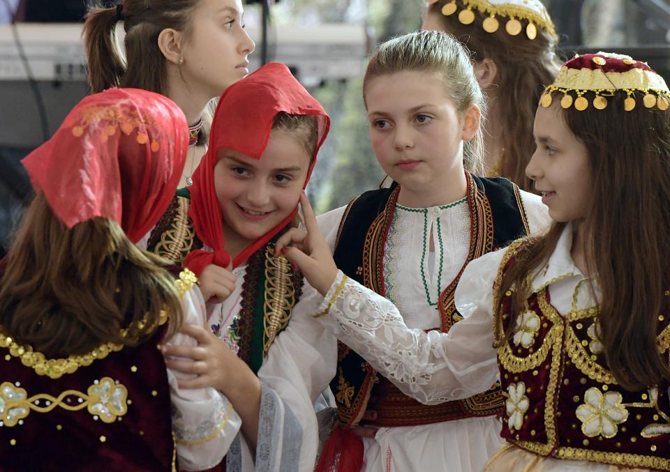 Young girls play with their scarves before performing traditional Albanian songs during the Albanian Festival at the 2019 St. Mary's Assumption Orthodox Church.