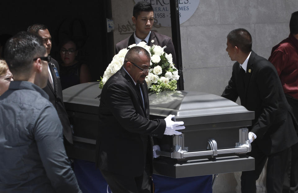 Pall bearers roll out the casket containing the remains of Ivan Manzano, who was killed in the El Paso mass shooting, from a funeral home in Ciudad Juarez, Mexico, Friday, Aug. 9, 2019. Families of those killed when a gunman opened fire at an El Paso Walmart are gathering at funerals on each side of the U.S.-Mexico border to remember loved ones. (AP Photo/Christian Chavez)