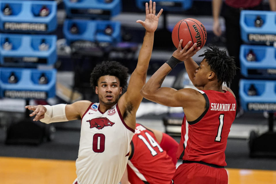 Texas Tech guard Terrence Shannon Jr. (1) shoots over Arkansas forward Justin Smith (0) in the first half of a second-round game in the NCAA men's college basketball tournament at Hinkle Fieldhouse in Indianapolis, Sunday, March 21, 2021. (AP Photo/Michael Conroy)