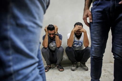 Relatives of Palestinian Zaki Ghanama, 25, mourn in the morgue of a hospital in Beit Lahia in the northern Gaza Strip