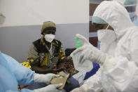 A COVID-19 patient is treated, at the Farcha provincial hospital in N'Djamena, Chad, Friday April 30, 2021. While the world's wealthier nations have stockpiled coronavirus vaccines for their citizens, many poorer countries are scrambling to secure enough doses, and some, like Chad, have yet to receive any. (AP Photo/Sunday Alamba)