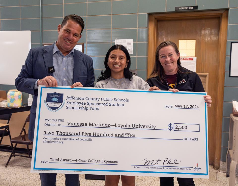 Atherton High School senior Vanessa Martinez Garduno, center, was presented with a scholarship check for $2,500 by JCPS Superintendent Marty Pollio on Friday morning. May 17, 2024.