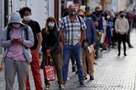 People wait in a line to get tested for the coronavirus disease in Prague