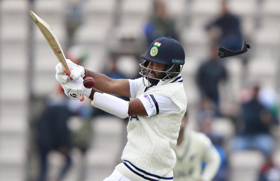 India's Cheteshwar Pujara is hit on his helmet on a delivery by New Zealand's Neil Wagner during the second day of the World Test Championship final cricket match between New Zealand and India, at the Rose Bowl in Southampton, England, Saturday, June 19, 2021. (AP Photo/Ian Walton)