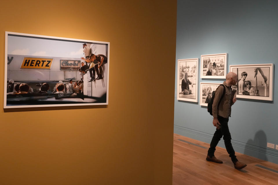 A visitor looks at pictures during a preview of Paul McCartney Photographs 1963-64: Eyes of the Storm exhibition at the National Portrait Gallery in London, Britain, Tuesday, June 27, 2023. The exhibition consists of unseen photographs taken by Paul McCartney from the Beatles at the height of Beatlemania. The gallery will open it's doors from June 28, 2023 until October 1, 2023. (AP Photo/Frank Augstein)