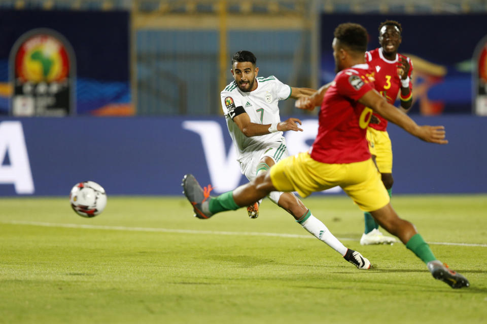 Algeria's Riyad Mahrez scores his team's second goal during the African Cup of Nations round of 16 soccer match between Guinea and Algeria in 30 June stadium in Cairo, Egypt, Sunday, July 7, 2019. (AP Photo/Ariel Schalit)