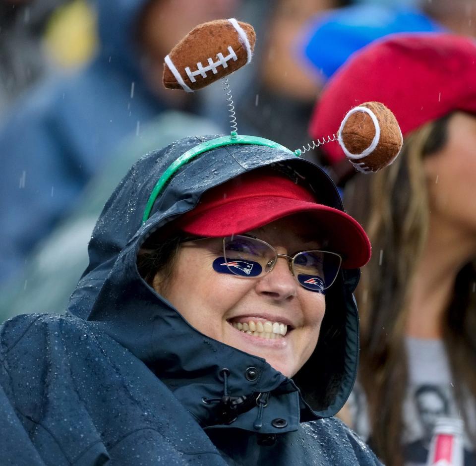 Fans brave the rain to watch the New England Patriots host the Philadelphia Eagles in their home opener at Gillette Stadium on Sunday.