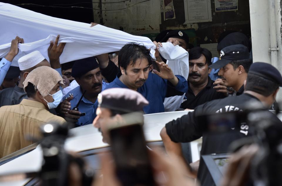 Police officers escort Shahbaz Gill, center in blue shirt, a political aide to former Pakistani prime minister Imran Khan, after a court appearance, in Islamabad, Pakistan, Monday, Aug. 22, 2022. Police arrested Gill earlier this month after he appeared on the private television channel ARY TV and urged soldiers and officers to refuse to obey “illegal orders” from the military leadership. Gill was charged with treason, which carries the death penalty under Pakistan's sedition act that stems from a British colonial-era law. (AP Photo)