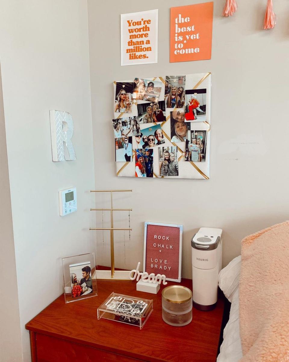 A boho dorm room with a photo wall and wall art