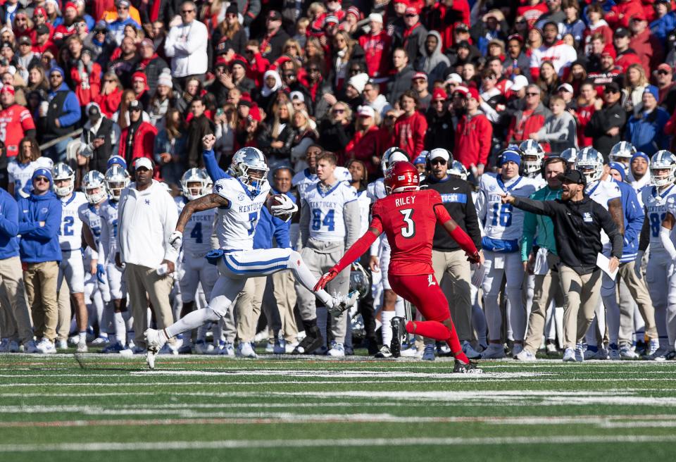 Kentucky's Barion Brown (7) high stepped for some yardage during first half action as the Cardinals and Wildcats faced off for the Governor's Cup on Saturday afternoon at L&N Stadium in Louisville, Ky. Nov. 25, 2023.