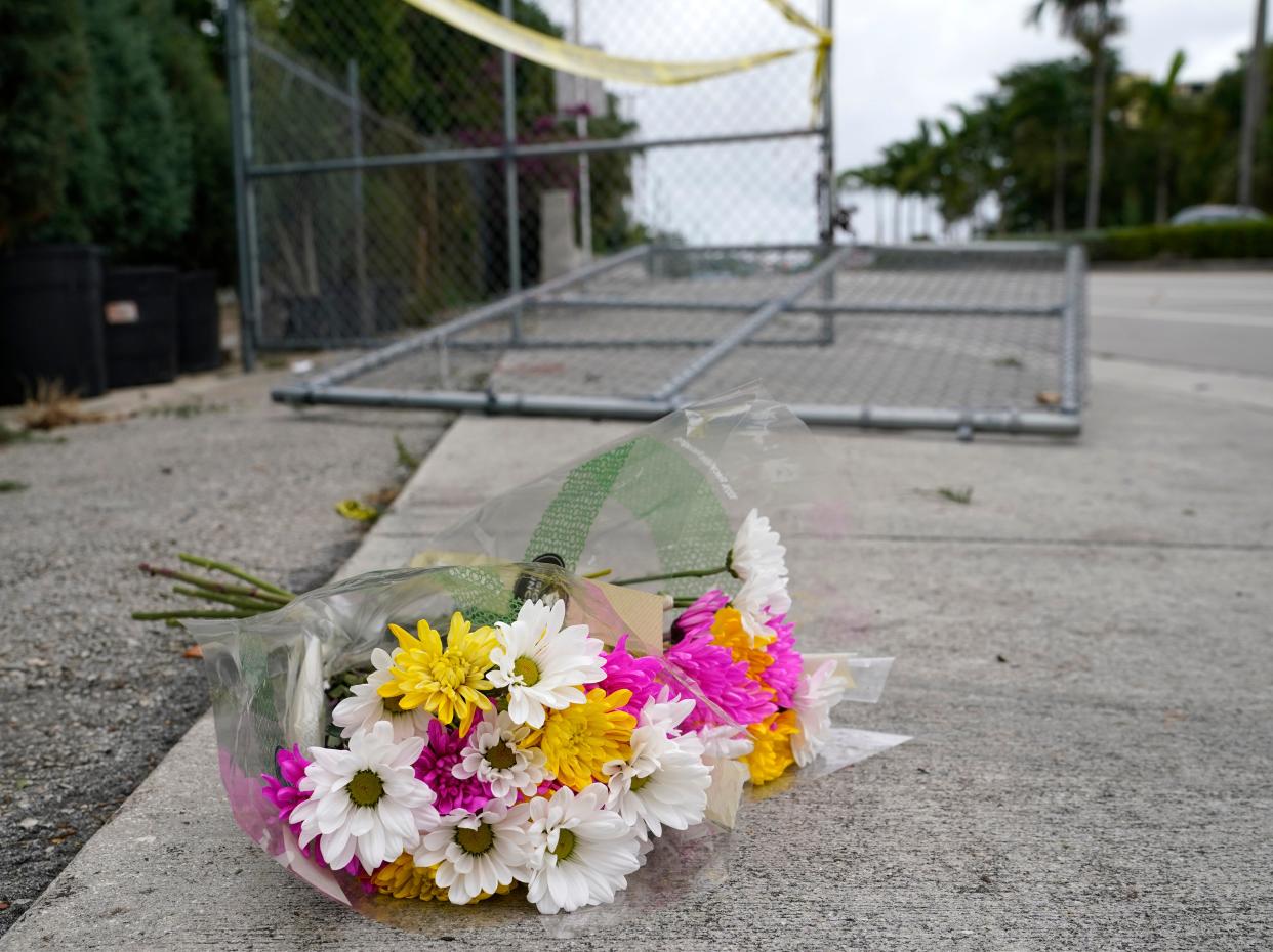 Flowers lie at the scene where a driver slammed into spectators at the start of a Pride parade Saturday evening, killing one man and seriously injuring another, Sunday 20 June 2021 (AP)