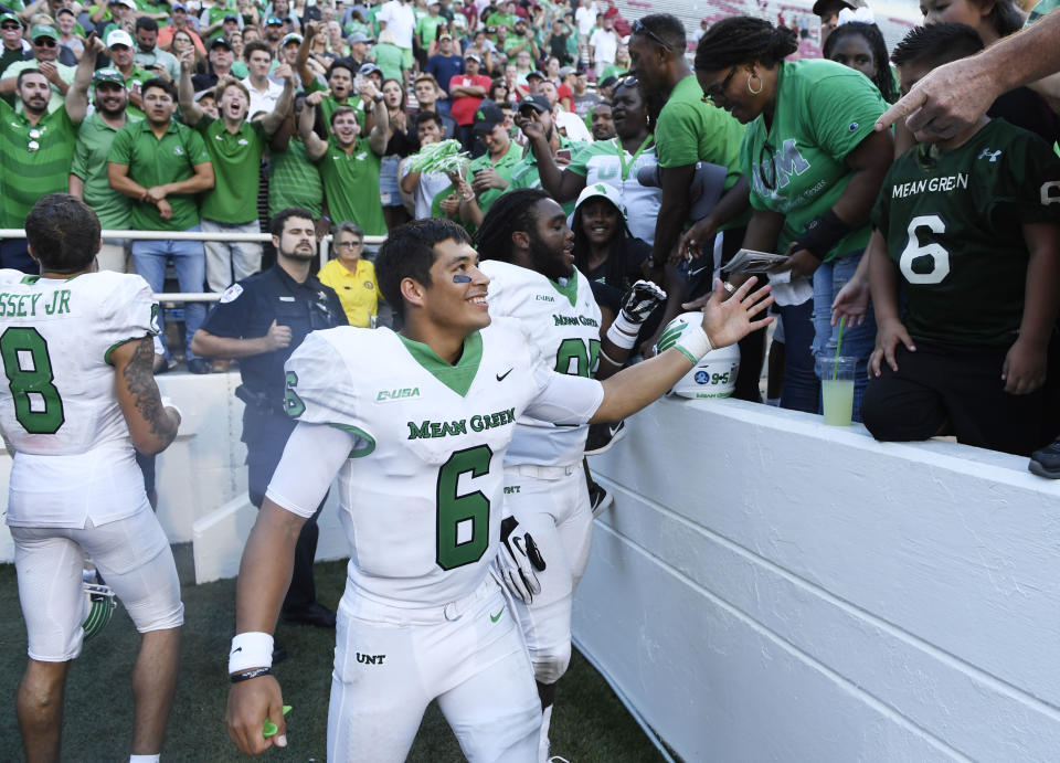 North Texas quarterback Mason Fine celebrates with fans after defeating Arkansas 44-17 after an NCAA college football game Saturday, Sept. 15, 2018, in Fayetteville, Ark. (AP Photo/Michael Woods)