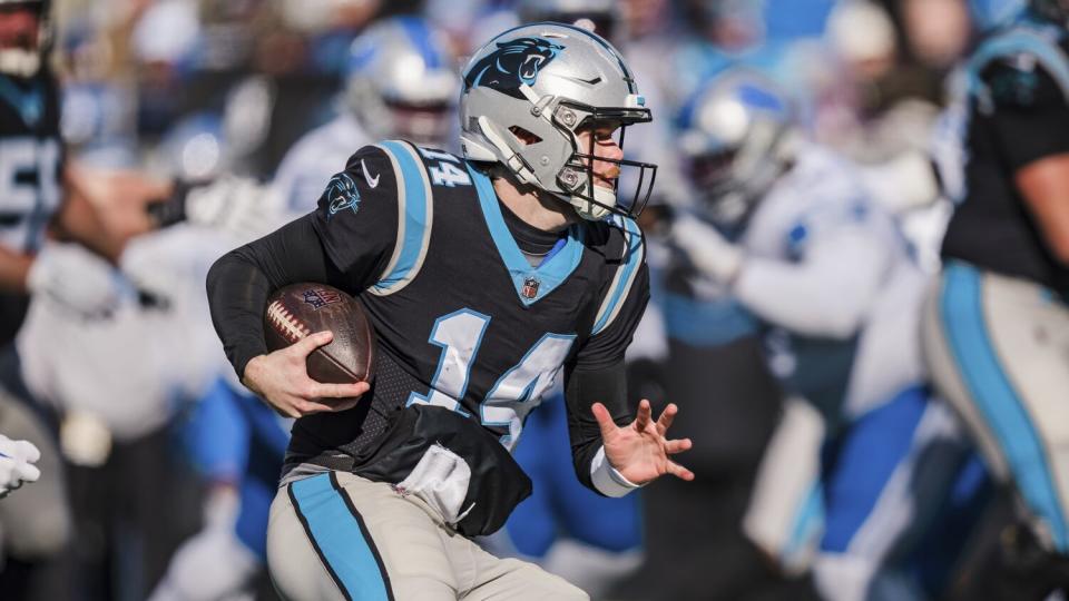 Carolina Panthers quarterback Sam Darnold runs with the ball against the Detroit Lions.