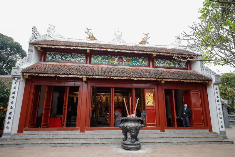 A man wears protetive mask as he guards at empty Ngoc Son temple due to recent novel coronavirus outbreak on Hoan Kiem lake in Hanoi