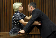 Oscar Pistorius, is greeted by his aunt Lois Pistorius, at court in Pretoria, South Africa, Tuesday, March 18, 2014. Pistorius is on trial for the murder of his girlfriend Reeva Steenkamp on Valentines Day, 2013. (AP Photo/Werner Beukes, Pool)