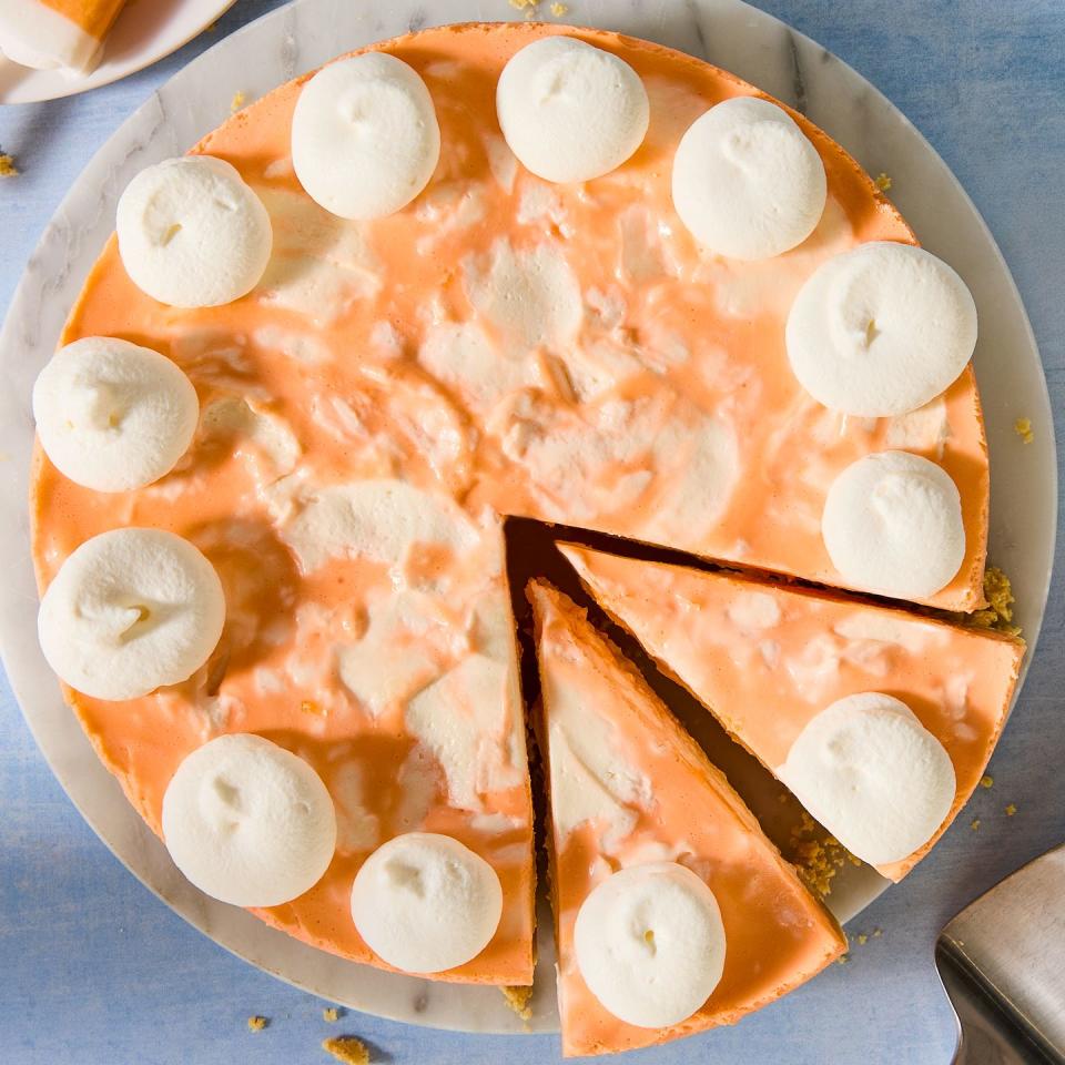 no bake creamsicle cheesecake with dollops of whipped cream and a graham cracker crust