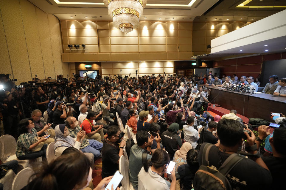 Malaysian opposition leader Anwar Ibrahim, center at the table, speaks during a press conference in Kuala Lumpur, Malaysia, Monday, Nov. 21, 2022. Anwar's reformist bloc secured 82 seats in the federal Parliament, far short of the 112 needed for a simple majority. (AP Photo/Vincent Thian)