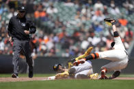 Pittsburgh Pirates' Rodolfo Castro, center, is tagged out at third base by San Francisco Giants third baseman J.D. Davis (7) during the fifth inning of a baseball game in San Francisco, Wednesday, May 31, 2023. (AP Photo/Tony Avelar)