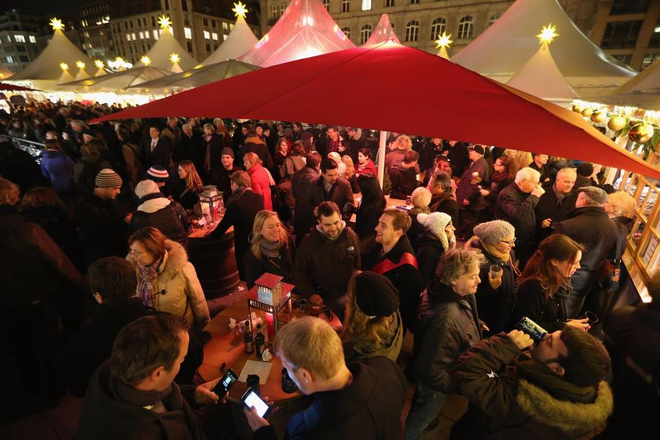 BERLIN, GERMANY - NOVEMBER 26: Visitors crowd a mulled wine stand at the annual Christmas market at Gendarmenmarkt on its opening day on November 26, 2012 in Berlin, Germany. Christmas markets, with their stalls selling mulled wine (Gluehwein), Christmas tree decorations and other delights, are an integral part of German Christmas tradition, and many of them opened across Germany today. (Photo by Sean Gallup/Getty Images)