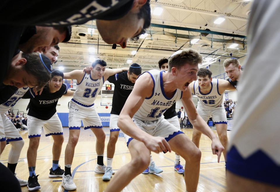 Yeshiva University Maccabees huddle around guard Ryan Turell (11) before a game against the U.S. Merchant Marine Academy (USMMA), in New York, Feb. 25, 2020. The Maccabees won the Skyline Conference quarterfinal 75-57. (AP Photo/Jessie Wardarski)