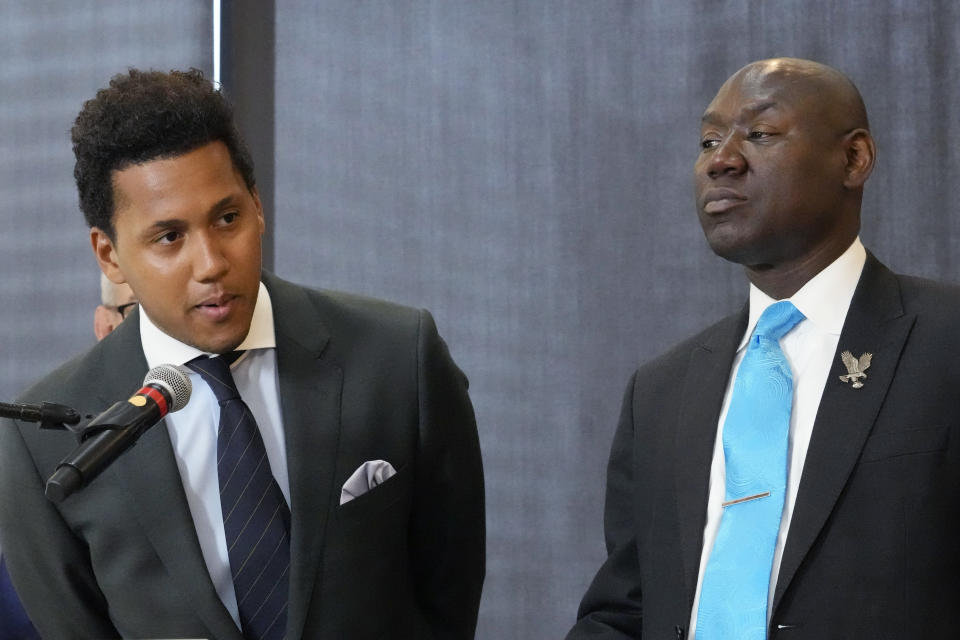 Former Northwestern quarterback Lloyd Yates, left, speaks as attorney Ben Crump, right, looks on at a news conference in Chicago, Monday, July 24, 2023. A Northwestern hazing scandal includes multiple sports, men and women, attorneys have said. (AP Photo/Nam Y. Huh)