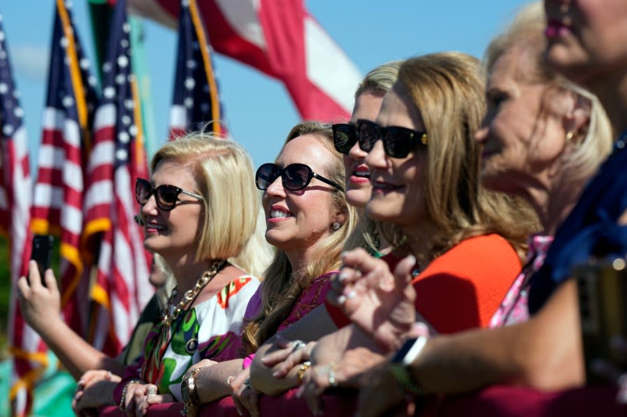 A group of supporters from North Carolina listen to Republican presidential candidate former President Donald Trump as he speaks at a campaign rally in Chesapeake, Va., Friday, June 28, 2024. Trump said the women had been to over one hundred of his rallies. (AP Photo/Steve Helber)