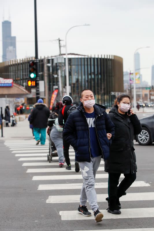 People wear masks following the outbreak of the novel coronavirus, in Chicago