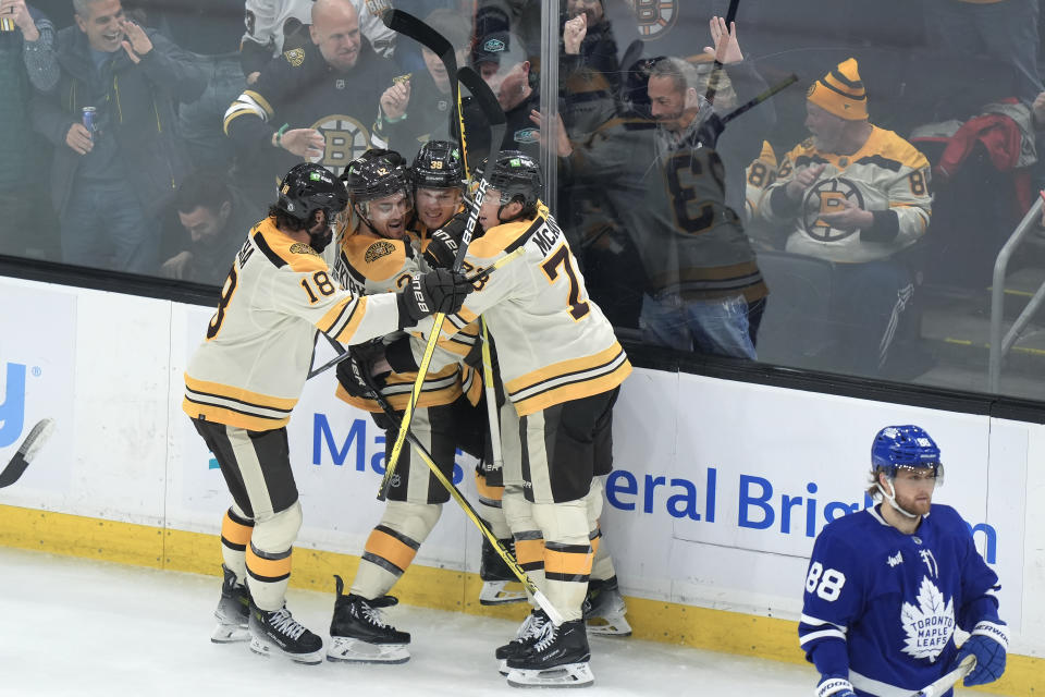 Boston Bruins center Morgan Geekie (39) celebrates with center Pavel Zacha (18), defenseman Kevin Shattenkirk (12) and defenseman Charlie McAvoy (73) as Toronto Maple Leafs right wing William Nylander (88) skates away after Geekie scored in the second period of an NHL hockey game, Thursday, March 7, 2024, in Boston. (AP Photo/Steven Senne)