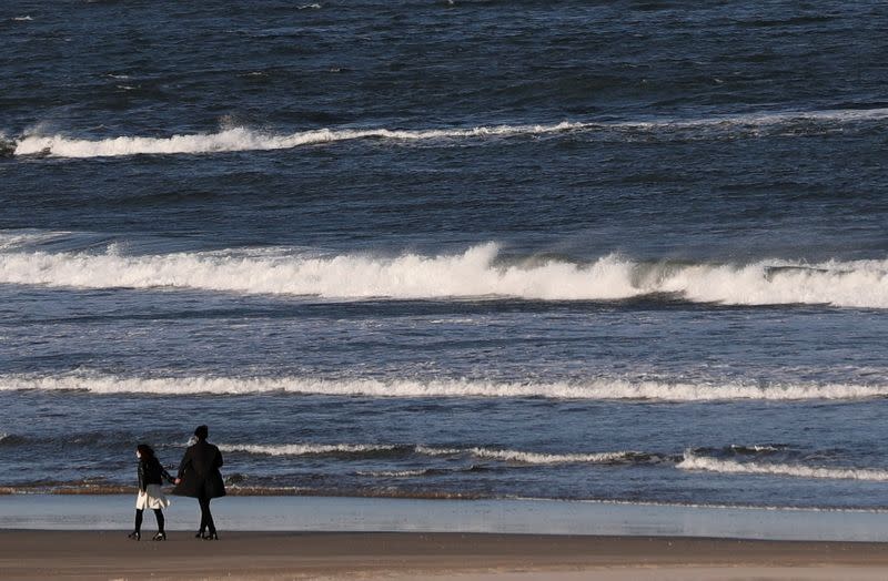 Couple walk on Usuiso beach ahead of the 10th anniversary of Fukushima disaster, in Iwaki